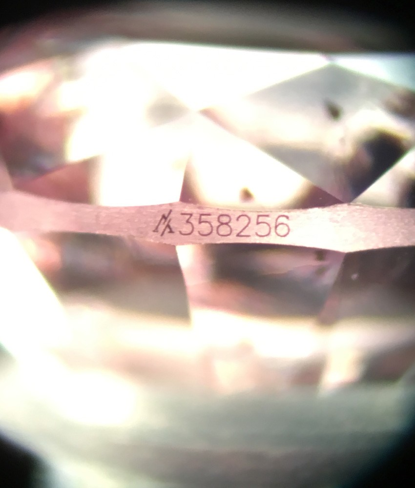 A unique lot number engraved on the girdle of diamond.