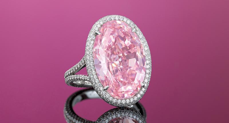 A stunning pink oval stone with mixed cuts ring.