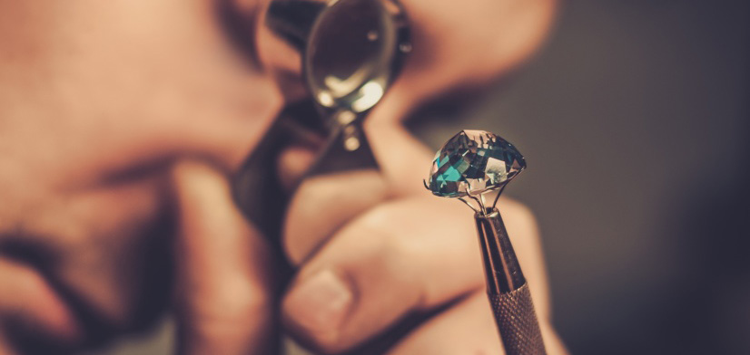 A man examines a diamond.