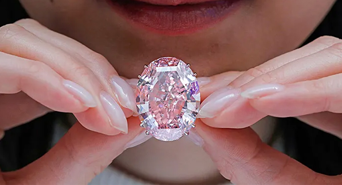 A woman holding the CTF pink star.
