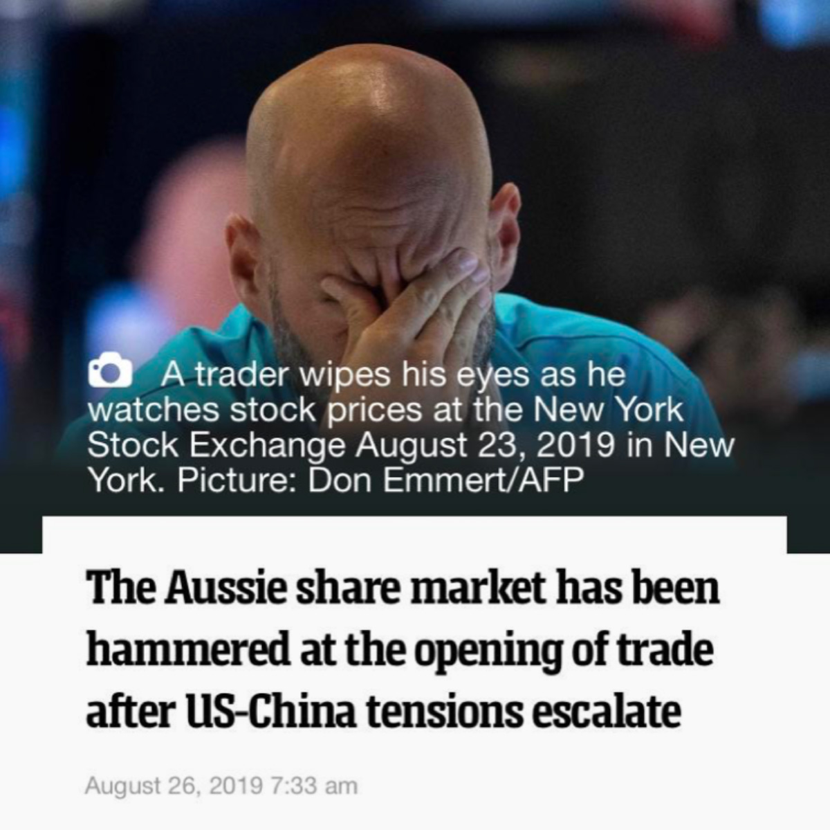 Trader wipes his eyes as he watches stock prices at the New York Stock Exchange.