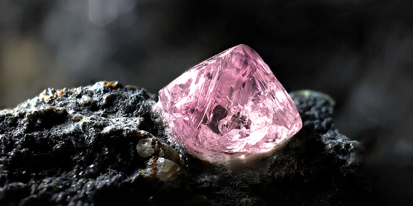 A rough diamond embedded in rock.