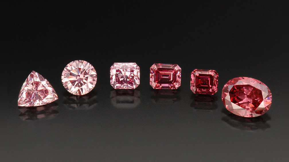 Six pink diamonds on a back background.